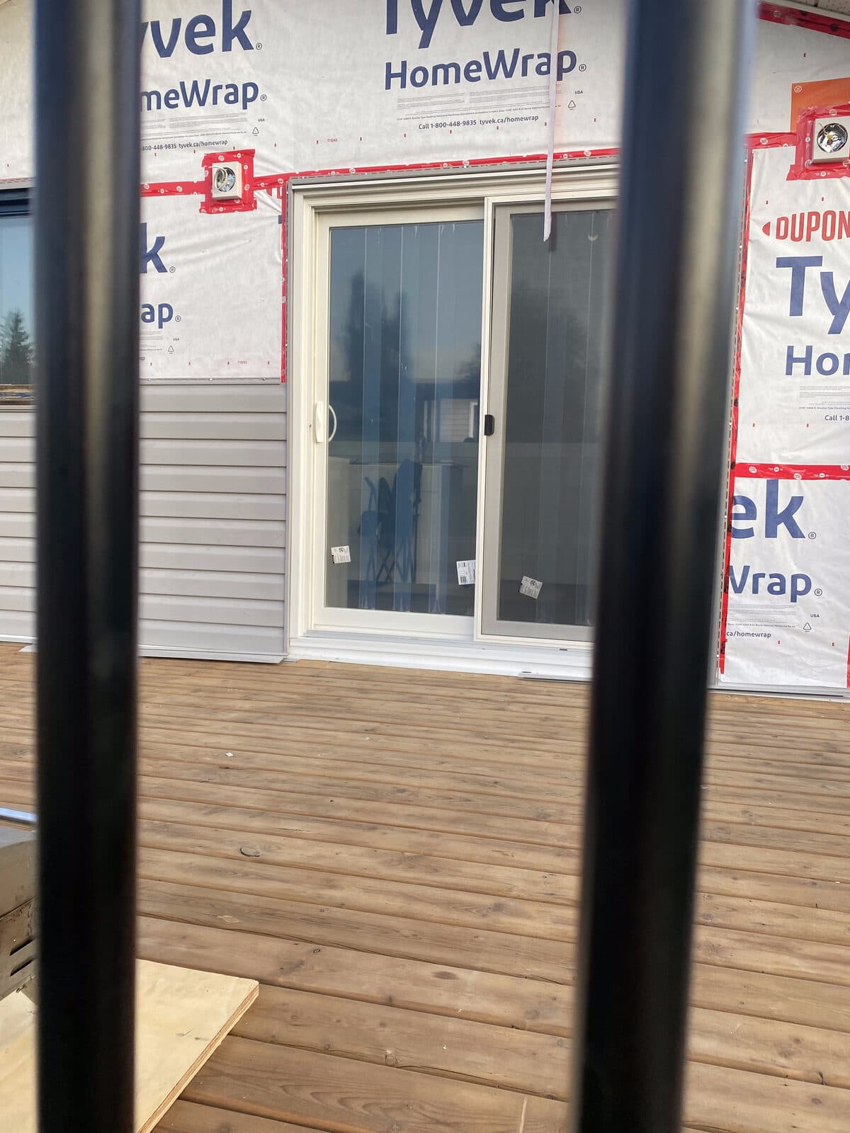 Cedar deck with sliding patio door — JFK Surfaces project in Central Alberta