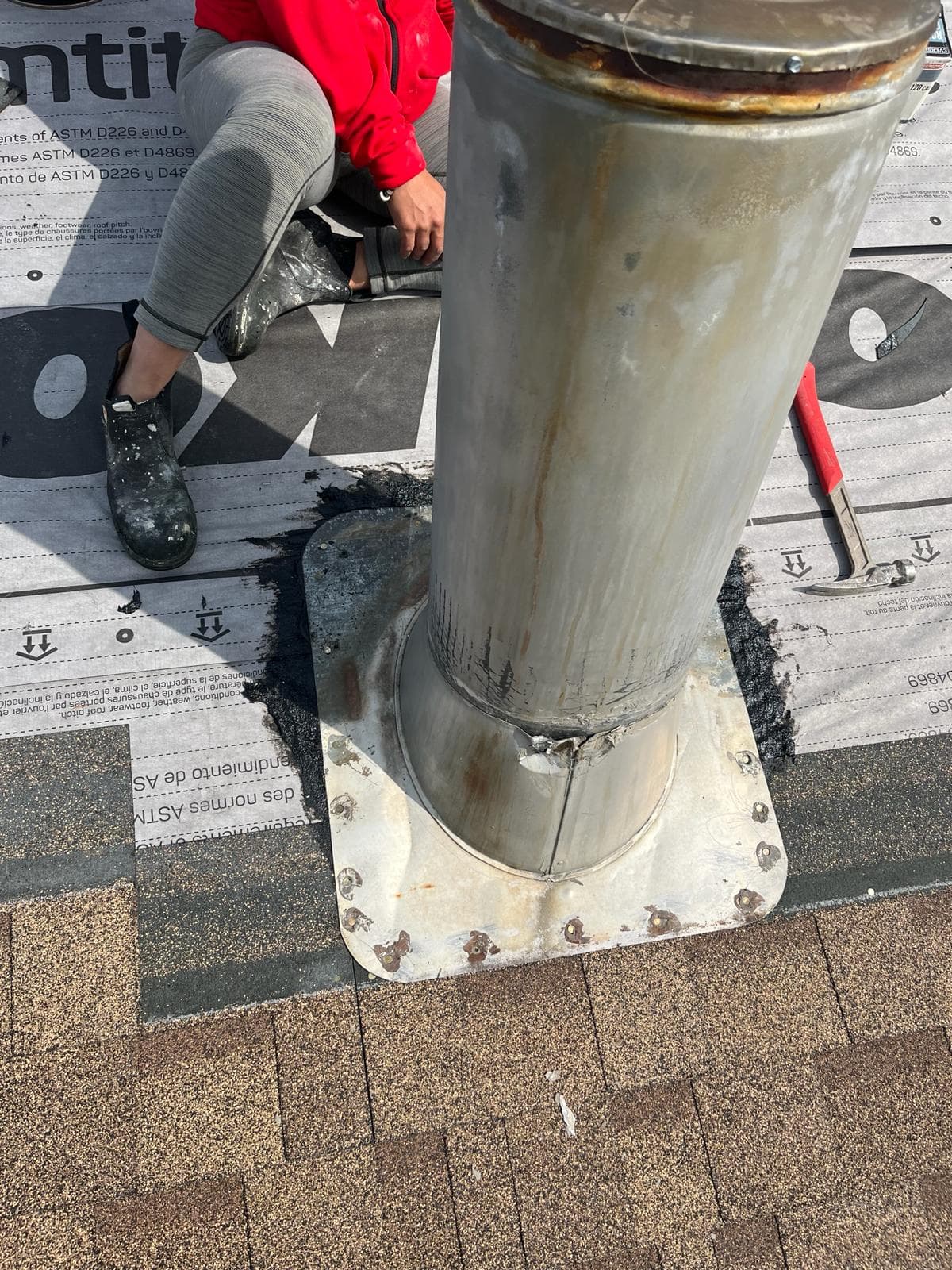 Asphalt shingle roof close-up showing plumbing vent flashing detail — JFK Surfaces Central Alberta